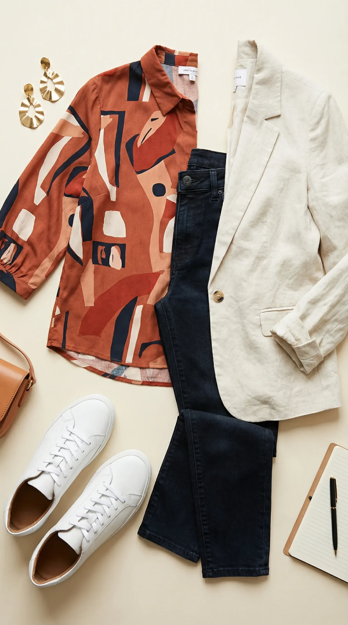 Business casual outfit for women in creative and tech offices — dark jeans, print blouse and linen blazer