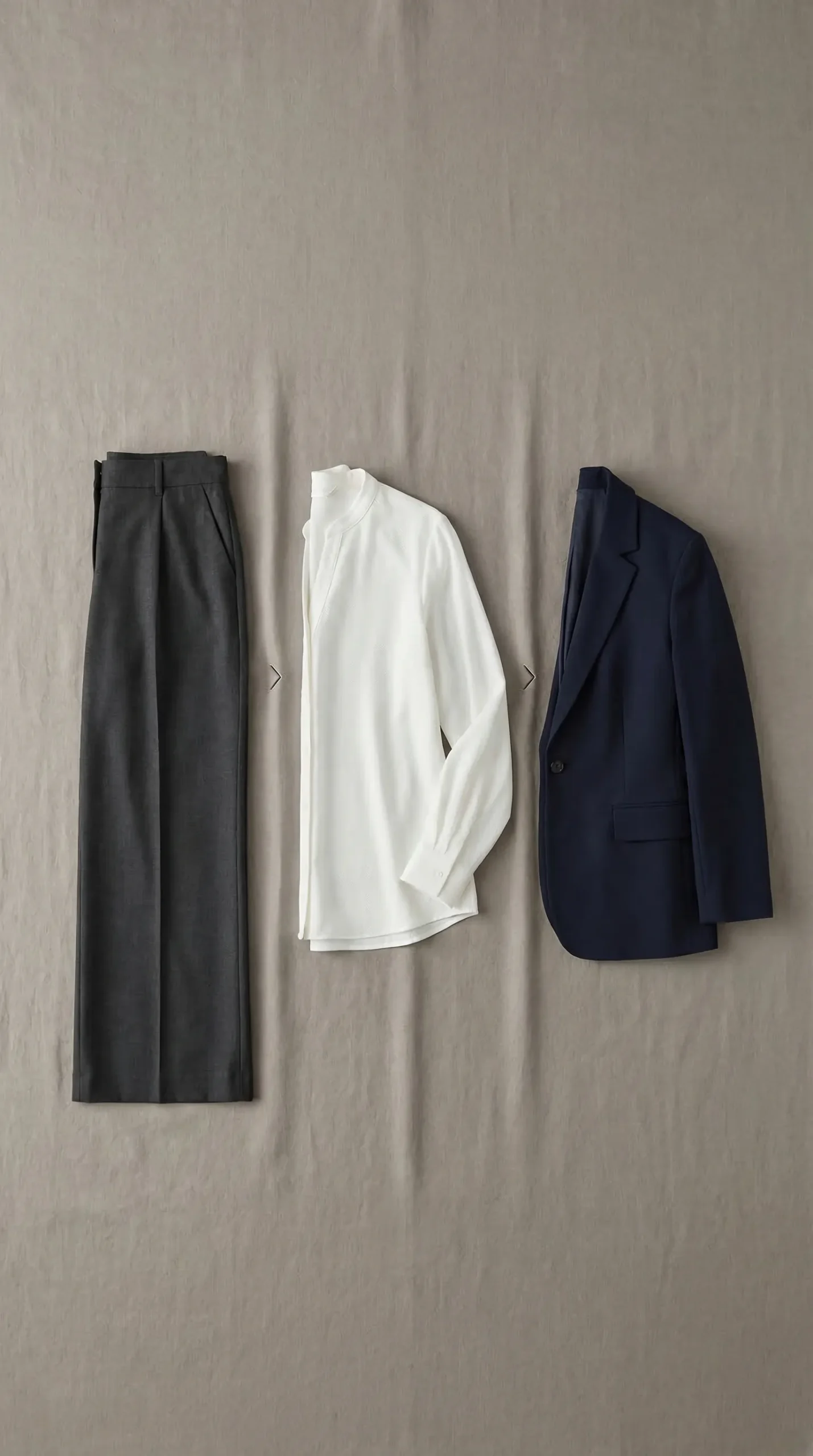 Flat lay of the three-part outfit formula — neutral bottom, structured top and blazer layer